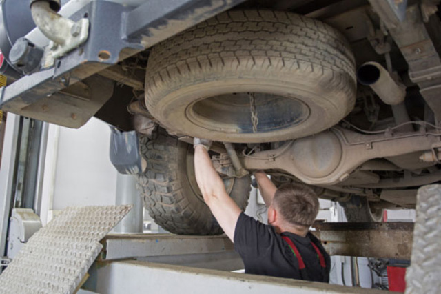 Man servicing a vehicle